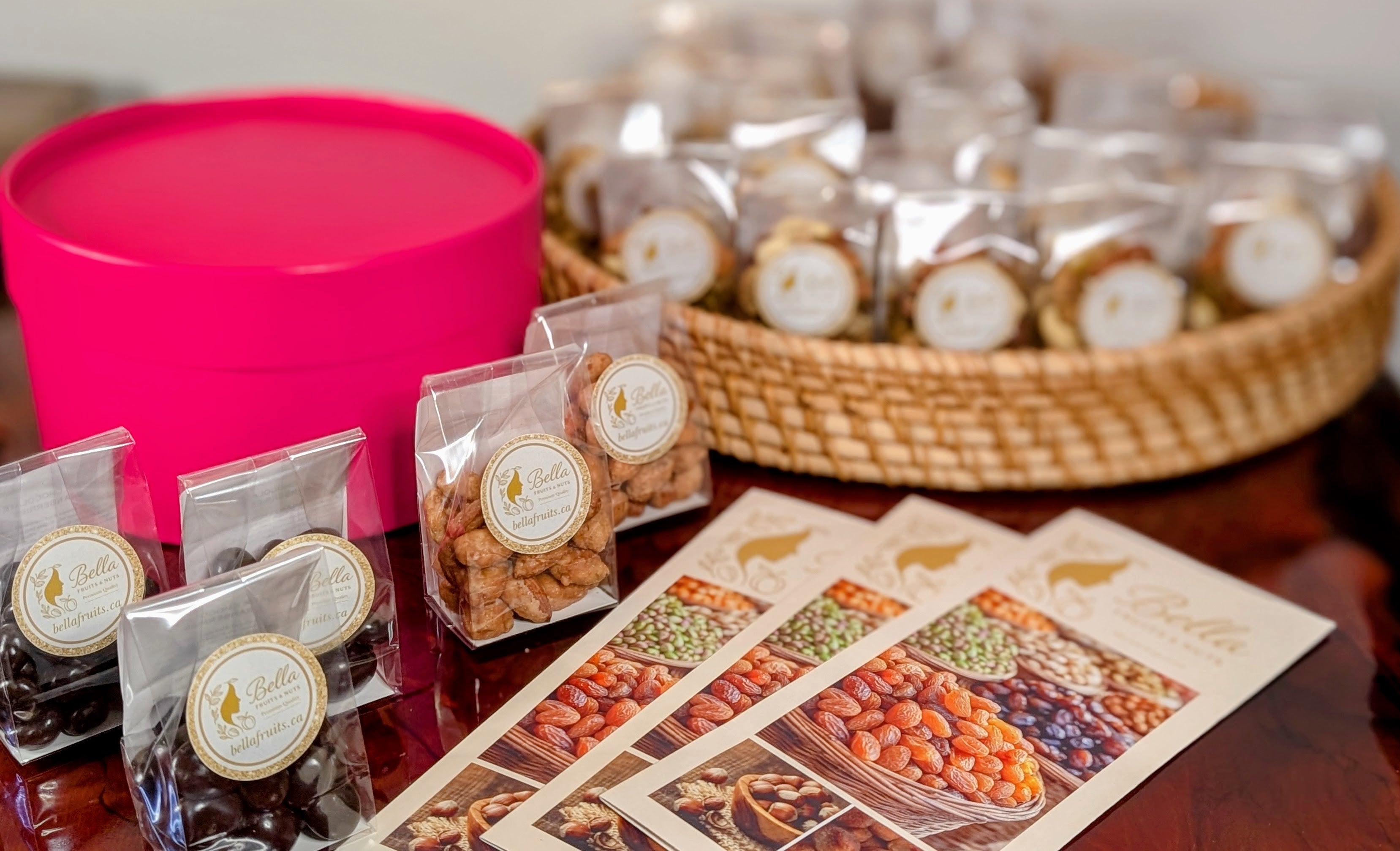 Snack packages with labels and a pink container on a table.